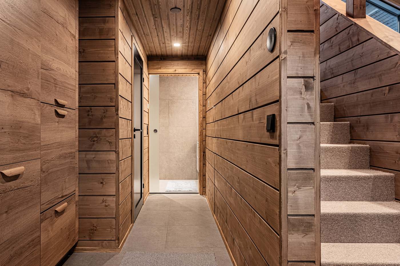 Corridor with cupboards, bathroom door and staircase