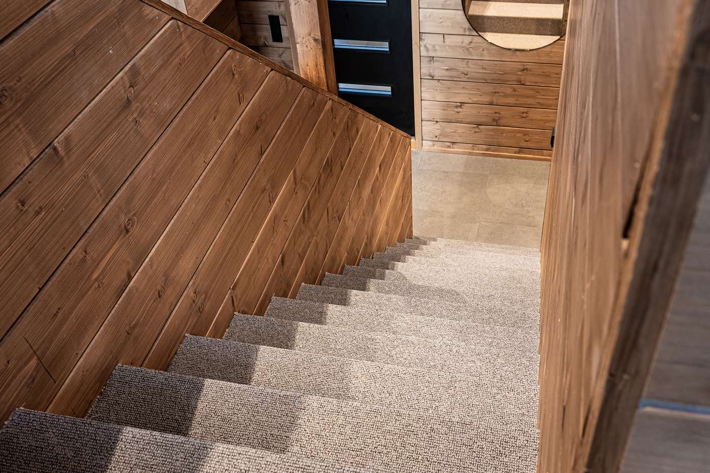 Staircase with timber walls and carpet